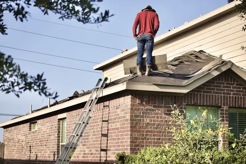Professional roofer working on a residential roof in Conroe